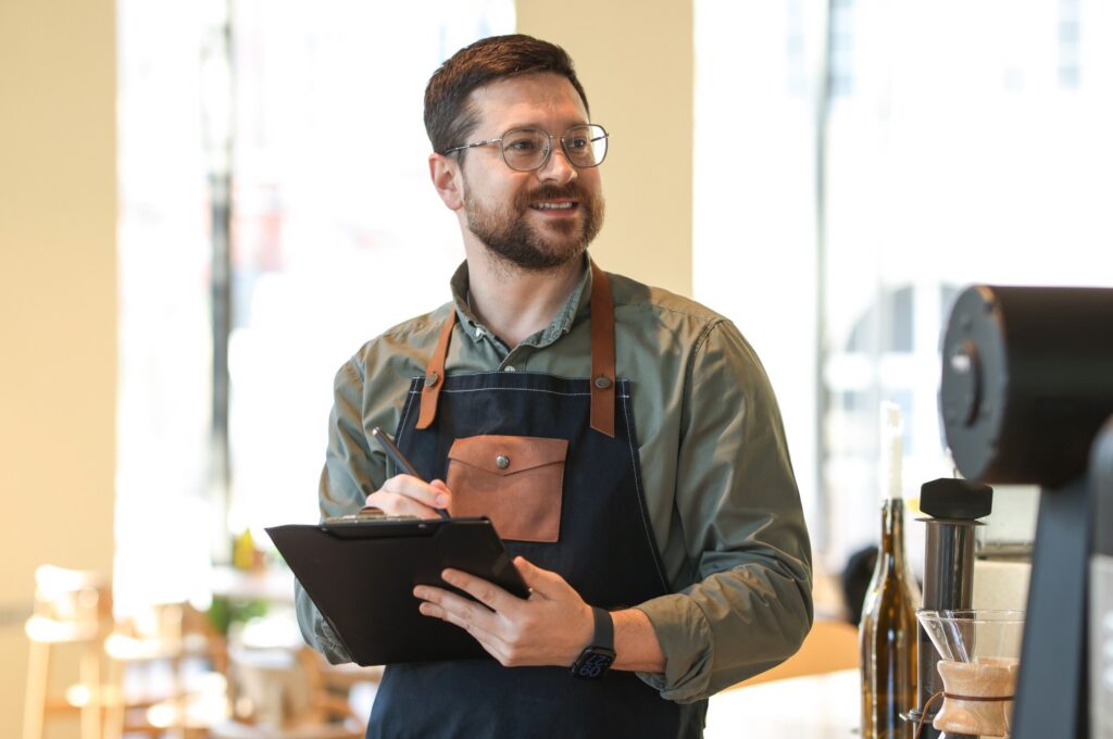 A business owner with a clipboard inspecting work.